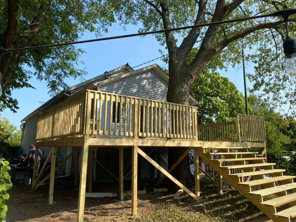 Timber deck with railings and a wide staircase