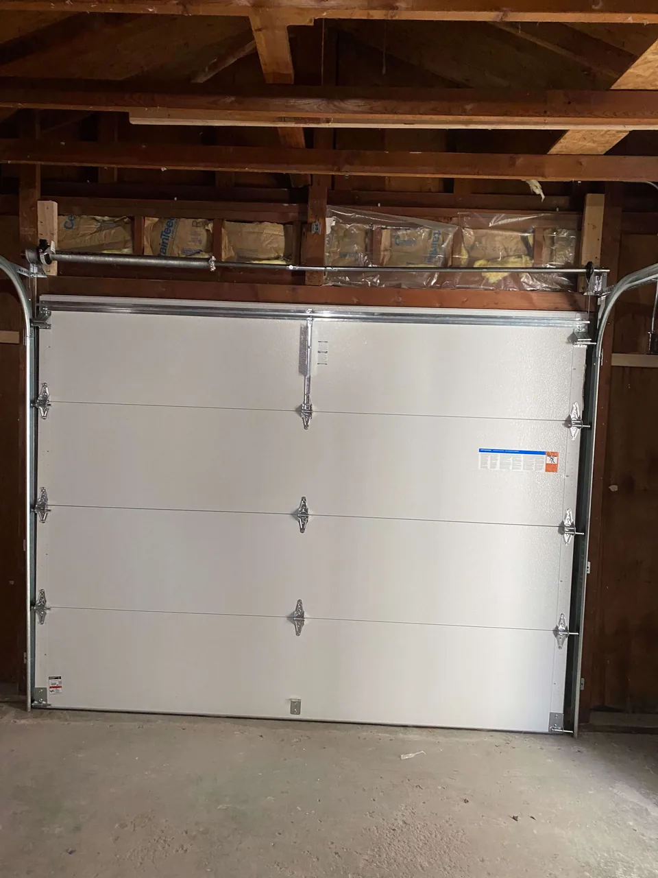 Garage interior showing the door and exposed framing
